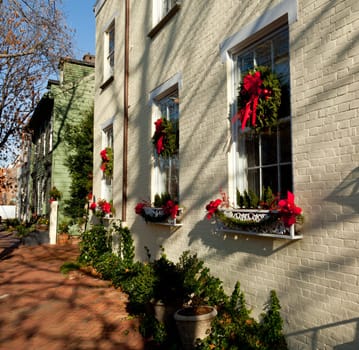 Old brick colonial house decorated for Christmas with wreath on door