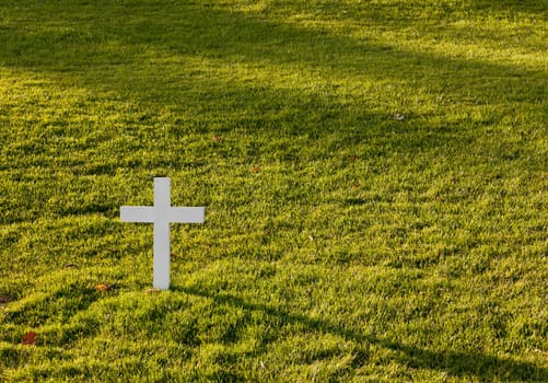 Simple white cross in lawn at Robert Kennedy memorial in Arlington Cemetery