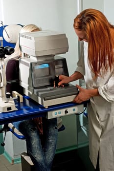 Young woman examining the eyesight in the optician&#039 s