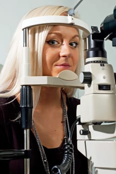 Young woman examining the eyesight in the optician&#039 s
