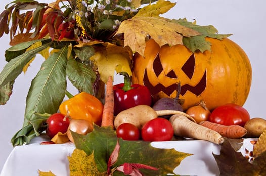 autumn composition of vegetables of leaves and the pumpkin halloween on the white background