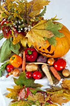 autumn composition of vegetables of leaves and the pumpkin halloween on the white background