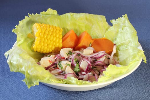 A plate of ceviche, a traditional Peruvian seafood dish, with sweet potato and sweet corn.