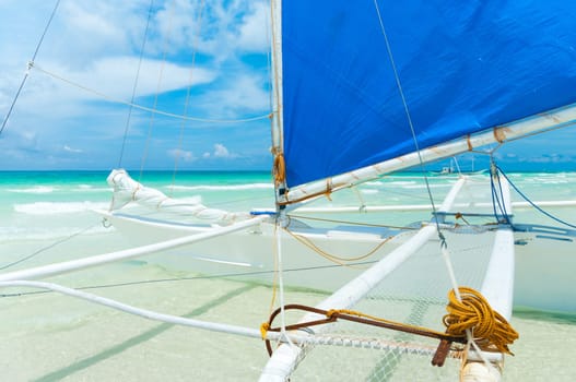 traditional paraw sailing boats on white beach on boracay island, Philippines