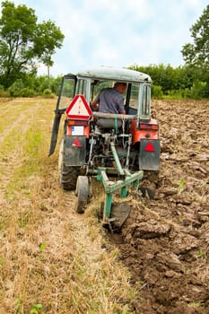 ploughing field on old tractor in southern Poland