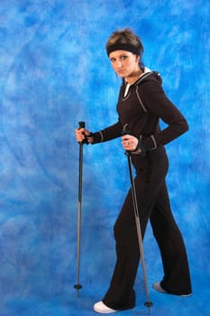 Young woman nordic walking on the blue mosaic background