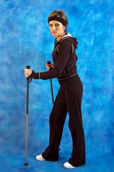 Young woman nordic walking on the blue mosaic background