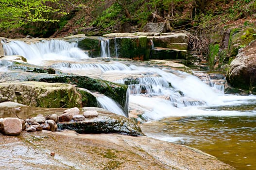 Cascading Waterfall Over Natural Rocks in Forest
