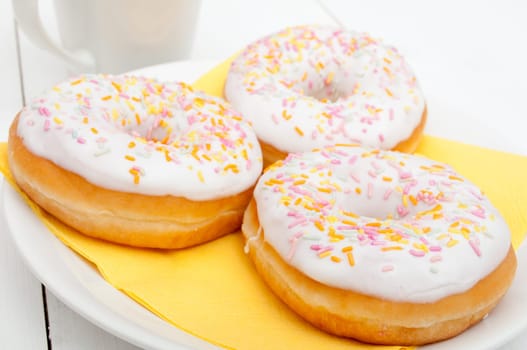 Donuts With Colorful Sprinkles, Plates and Mugs on Table