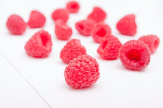 Fresh Ripe Raspberries on White Wooden Table