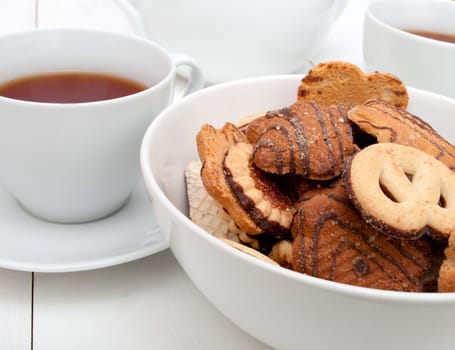 White Cups of Tea and Bowl With Biscuits on White Table