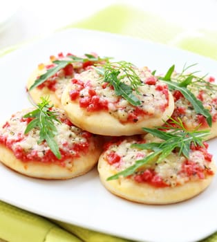 Small cakes with ham and cheese as appetizer