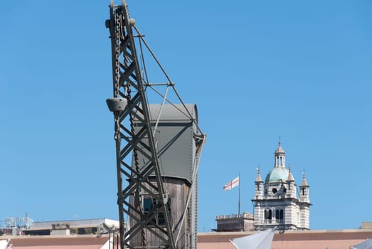 cranes with a dome of Genoa in the background