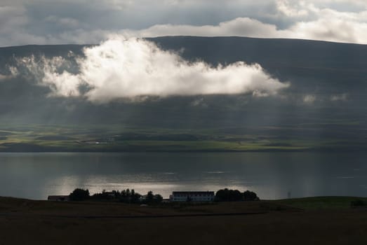 cloud with rays of sunshine to Akureyri in Iceland