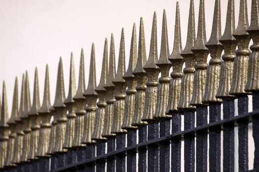 Metal fence with golden tips