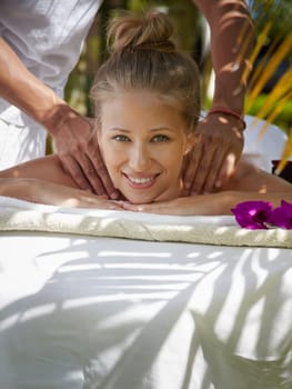 Young beautiful blonde caucasian woman gets massage and beauty treatment in luxury resort