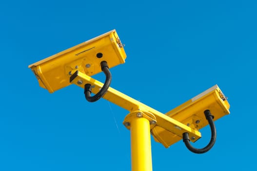 double surveillance security camera or CCTV against blue sky