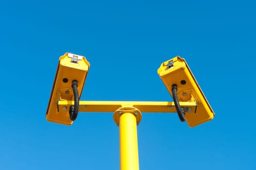 double surveillance security camera or CCTV against blue sky