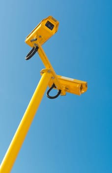 double surveillance security camera or CCTV against blue sky