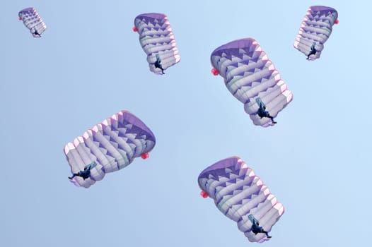 Many parachutes over a blue sky background