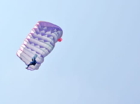 A parachute over a blue sky background