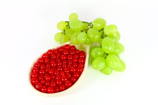 Grape and red currant isolated on white
