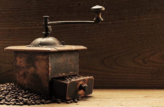Roasted coffee beans are ground in a coffee grinder.