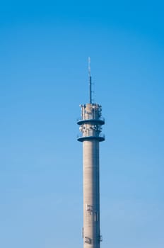 large tower full with antennas and satellite dishes