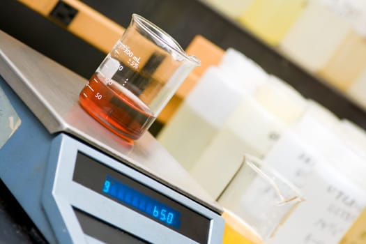 Chemical laboratory equipment - beaker with oil on the scale.