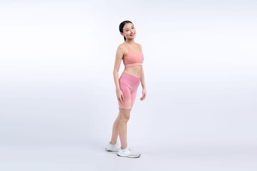 Full body asian woman in sportswear portrait, smiling and posing cheerful gesture. Workout training with attractive girl engage in her pursuit of healthy lifestyle. Isolated background Vigorous