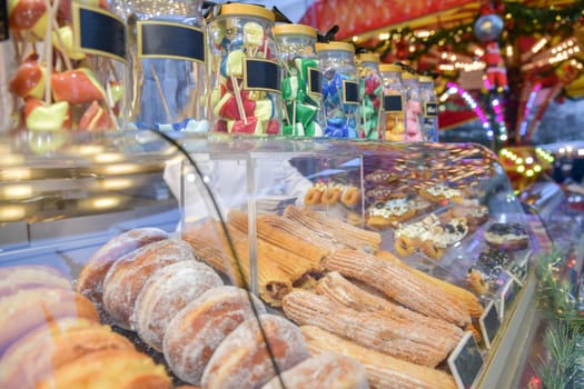 Lollipop donuts and cakes on a counter at the christmas market in France