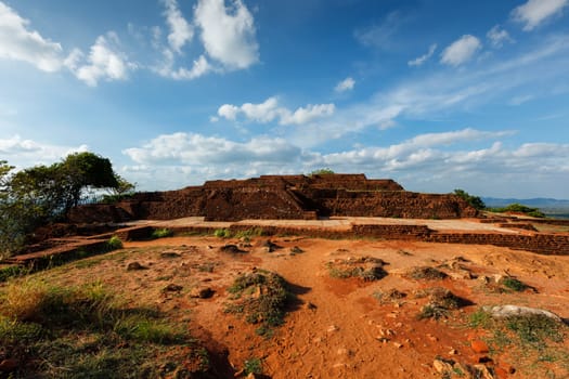 Famous tourist landmark of Sri Lanka - ancient Sigiriya rock (Lion rock) with palace fortress ruins on top in Sigiriya, Sri Lanka. UNESCO World Heritage Site