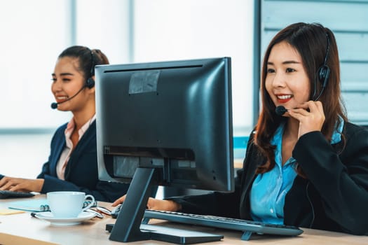 Business people wearing headset working in office to support remote customer or colleague. Call center, telemarketing, customer support agent provide service on telephone video conference call. Jivy