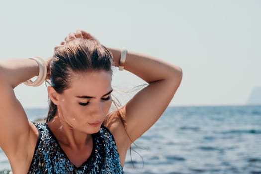 Woman travel sea. Young Happy woman in a long red dress posing on a beach near the sea on background of volcanic rocks, like in Iceland, sharing travel adventure journey