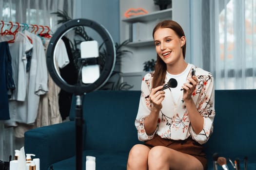 Woman influencer shoot live streaming vlog video review makeup utmost social media or blog. Happy young girl with cosmetics studio lighting for marketing recording session broadcasting online.