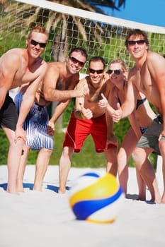 Beach volleyball, sports ball and team thumbs up for yes, competition or game collaboration agreement. Emoji like sign, group opinion vote or athlete for fitness, exercise or training on nature sand.