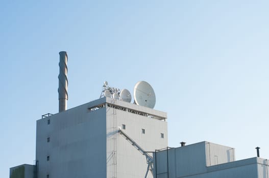 satellite dishes on top of a building