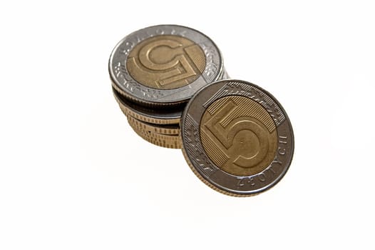 money in coins on a white background arranged in a pyramid
