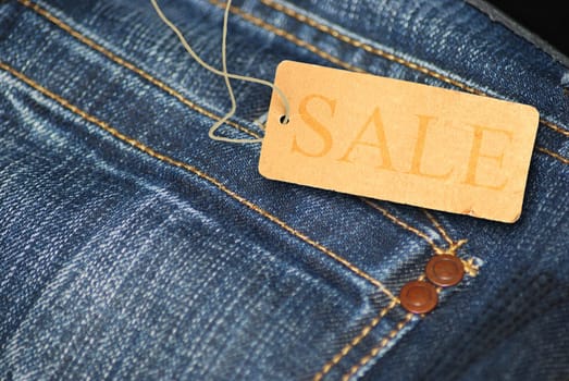 Red Sale Sign With Jeans in Background