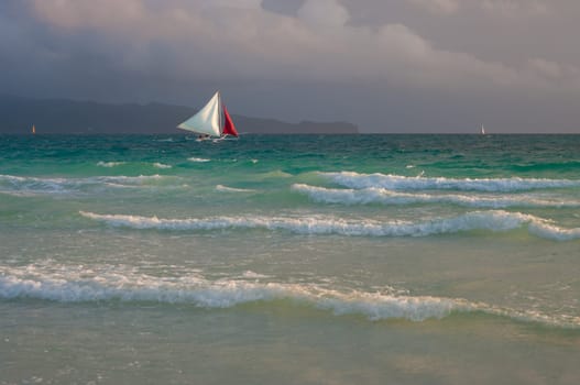 sailing boat with white and red sails