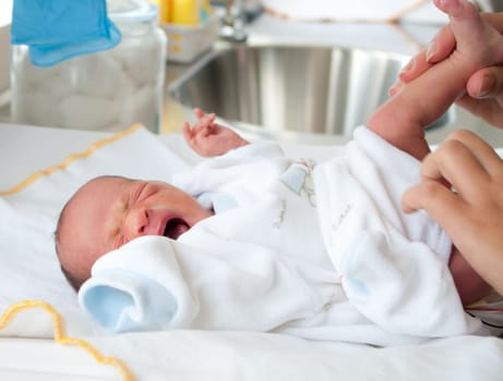 baby crying while he gets his diapers changed