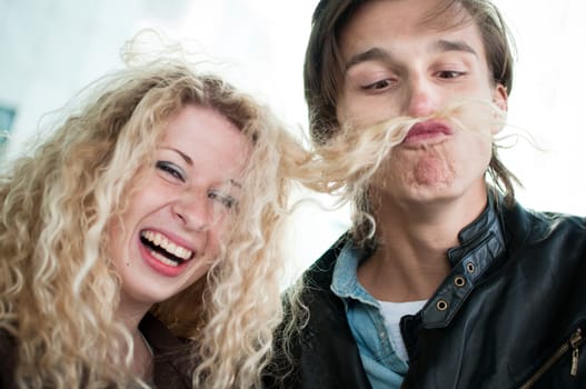 Big fun - couple playing with hair