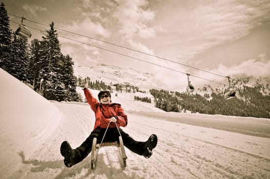 Winter people series - senior woman on sledge having fun in white snowy country