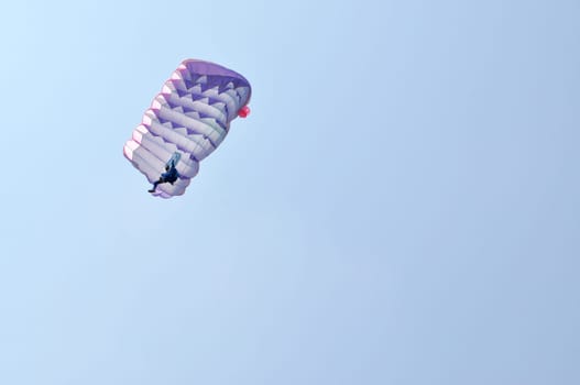 A parachute over a blue sky background