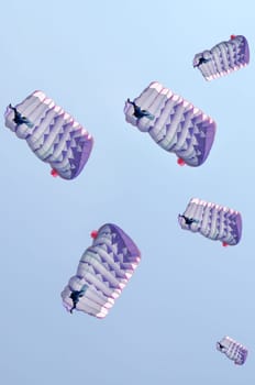 Many parachutes over a blue sky background