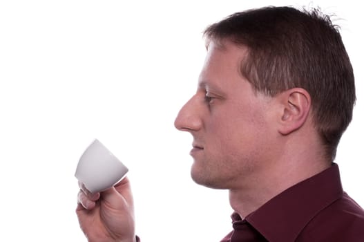 A man drinks an espresso coffee from a cup