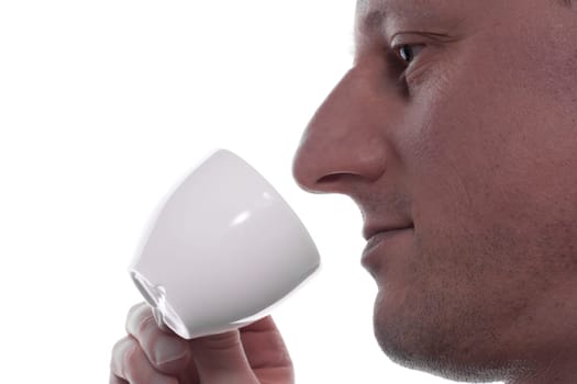 A man drinks an espresso coffee from a cup