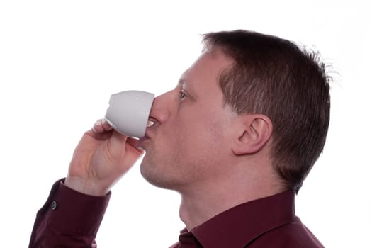 A man drinks an espresso coffee from a cup