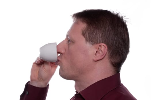 A man drinks an espresso coffee from a cup