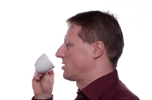 A man drinks an espresso coffee from a cup